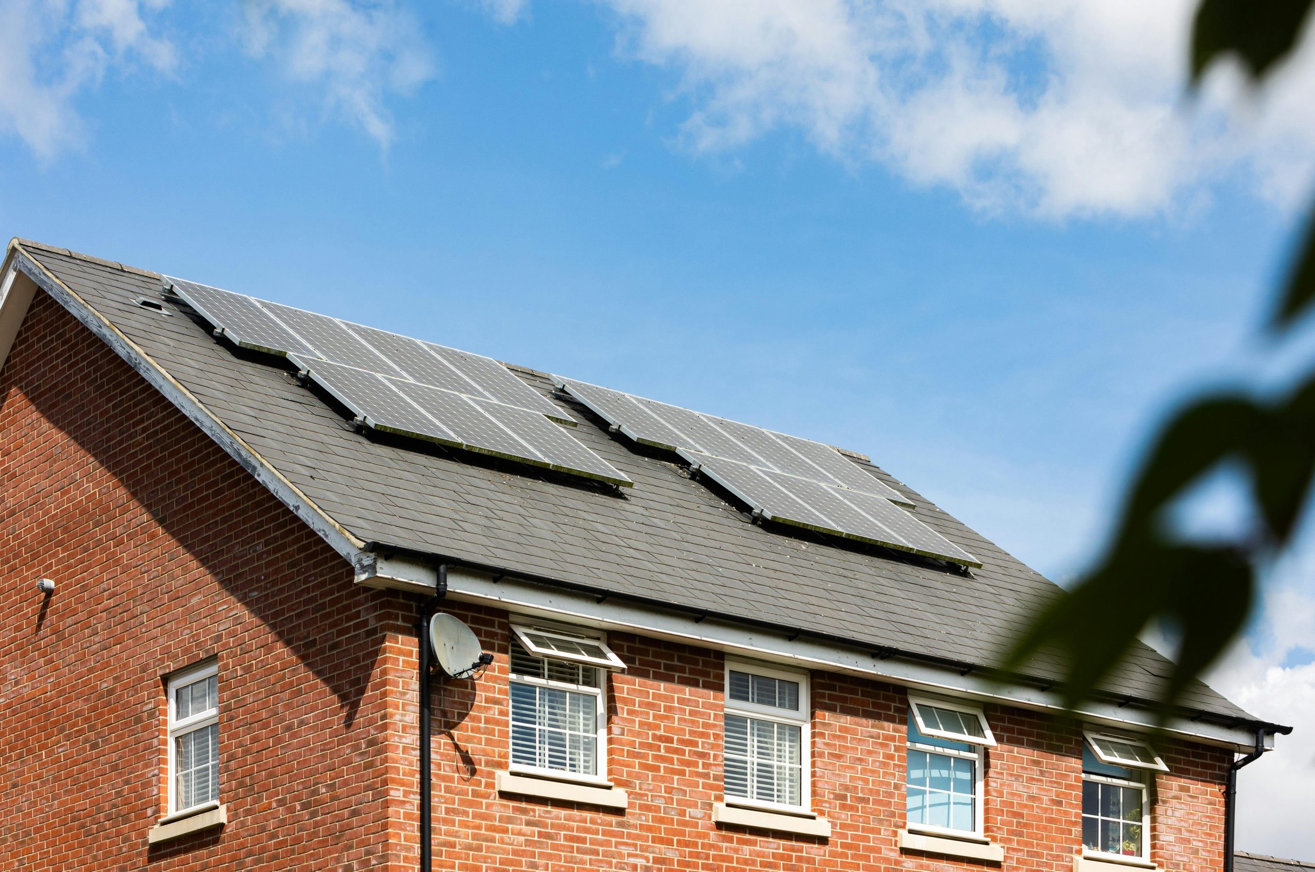 a brick house with solar panels on the roof